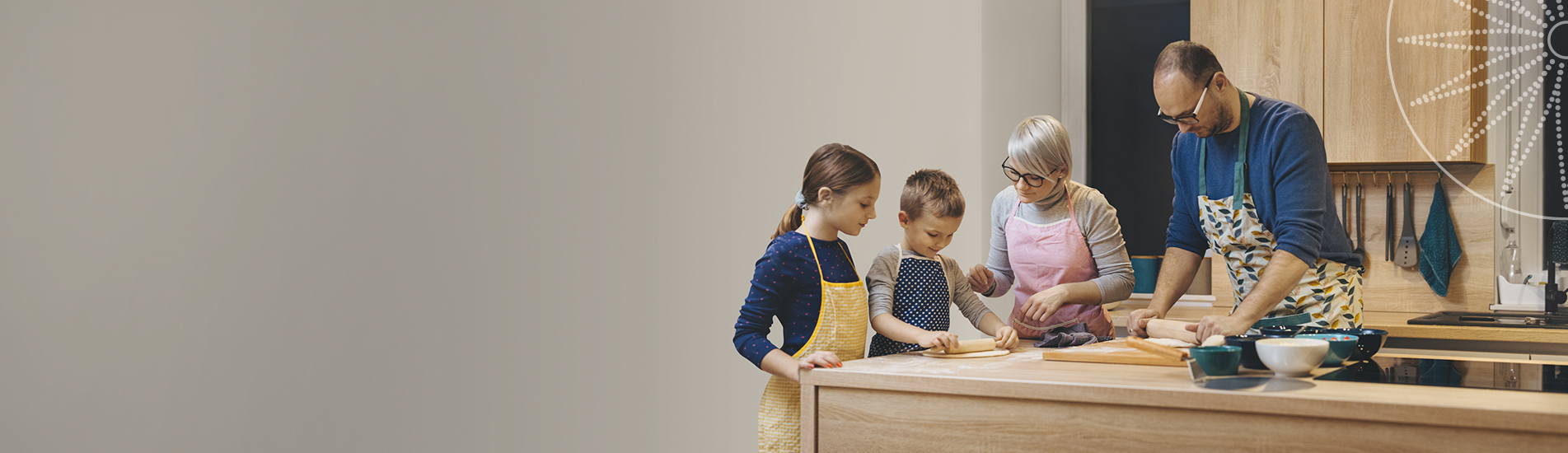 middle aged couple making pizza at home with their kids